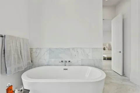a white bath tub sitting in a bathroom