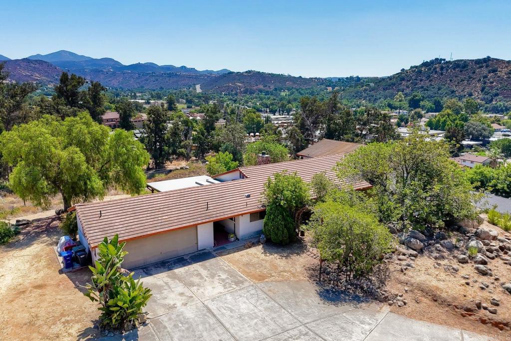 a view of a house with a yard and mountain