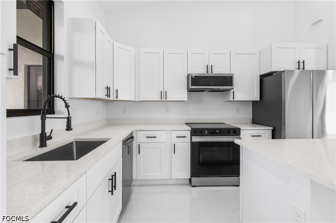 3004 South Tulip Road LaBelle, FL 33935 - Photo 12 of 24 a kitchen with stainless steel appliances granite countertop a sink stove and refrigerator