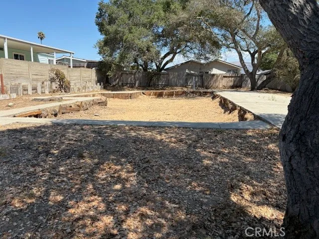 a view of yard with swimming pool and large trees