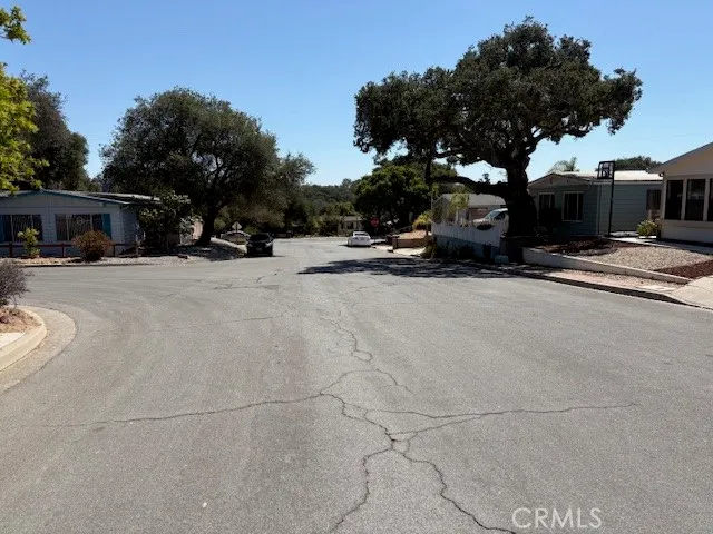 a view of a street with a car parked on the road