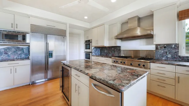 a kitchen with stainless steel appliances granite countertop a stove and a sink