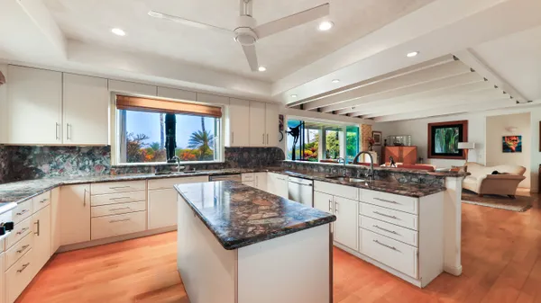 a view of a dining area with furniture and a kitchen