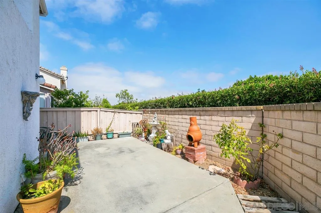 8727 Westmore Road, Unit 5 San Diego, CA 92126 - Photo 14 of 14 a view of a lake with a house in the background