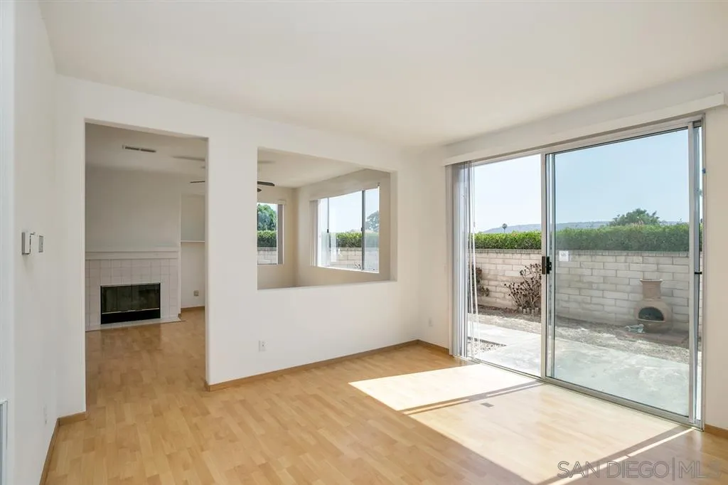 8727 Westmore Road, Unit 5 San Diego, CA 92126 - Photo 4 of 14 a bedroom with a bed and a fireplace