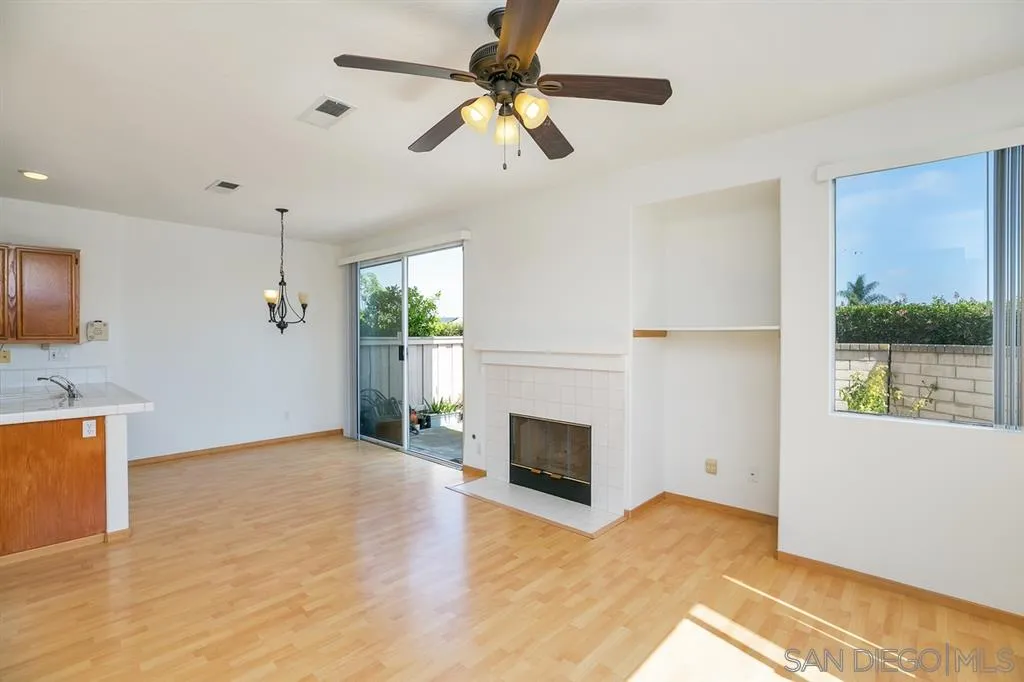 8727 Westmore Road, Unit 5 San Diego, CA 92126 - Photo 7 of 14 a view of an empty room with a fireplace and a window