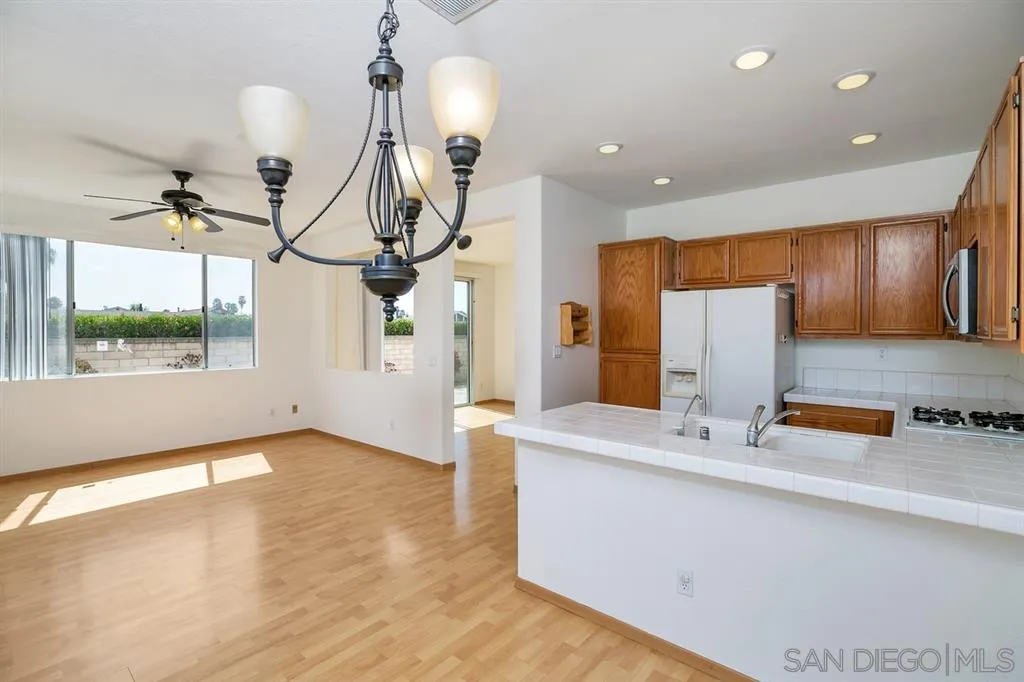 8727 Westmore Road, Unit 5 San Diego, CA 92126 - Photo 9 of 14 a view of a kitchen with a sink and a living room view