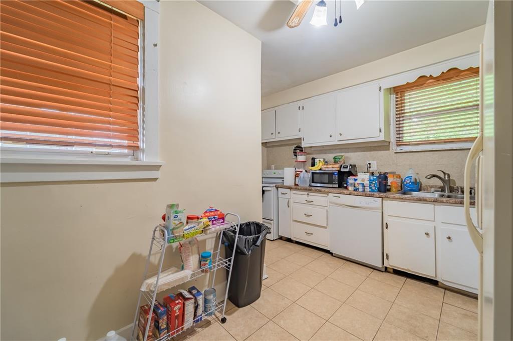 624 Frayne Street Pittsburgh, PA 15207 - Photo 12 of 21 a kitchen with white cabinets and window