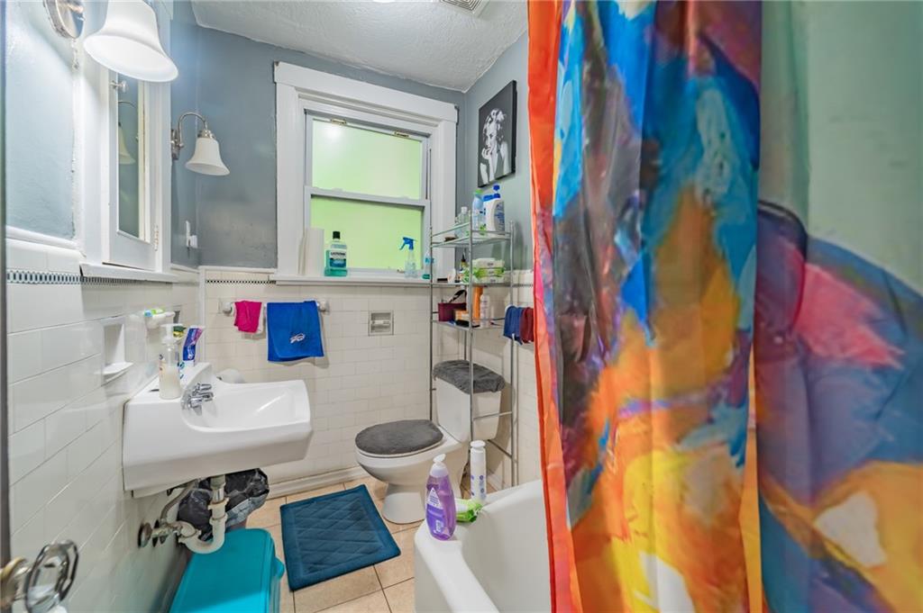 624 Frayne Street Pittsburgh, PA 15207 - Photo 14 of 21 a bathroom with a sink and a mirror