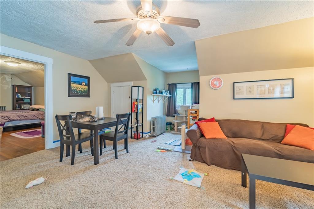 624 Frayne Street Pittsburgh, PA 15207 - Photo 15 of 21 a living room with furniture and a dining table