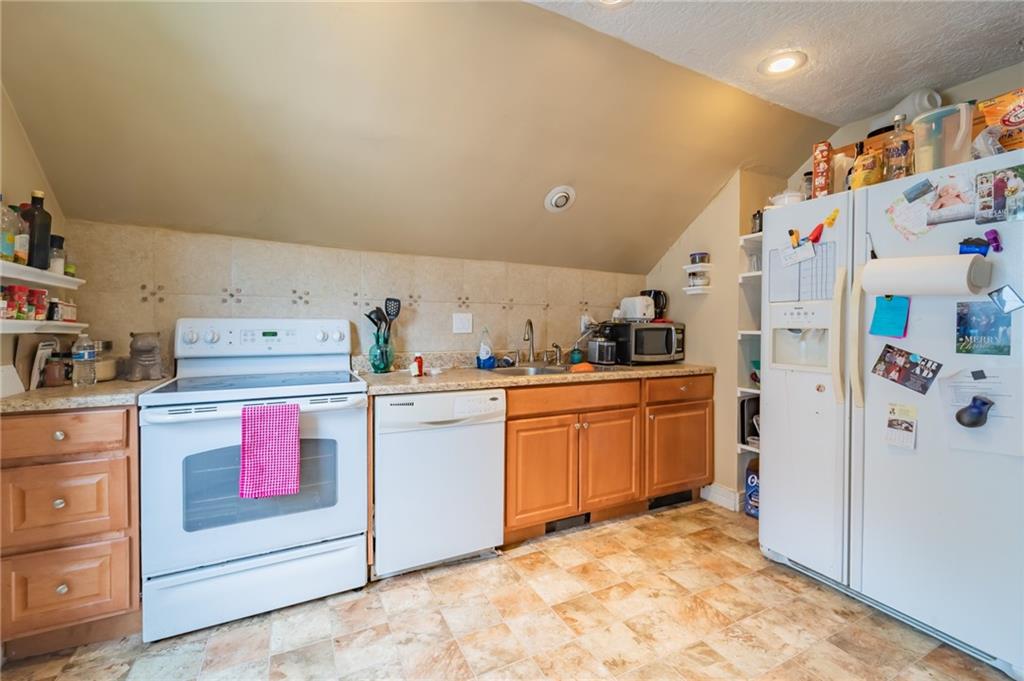 624 Frayne Street Pittsburgh, PA 15207 - Photo 18 of 21 a kitchen with a refrigerator and white cabinets