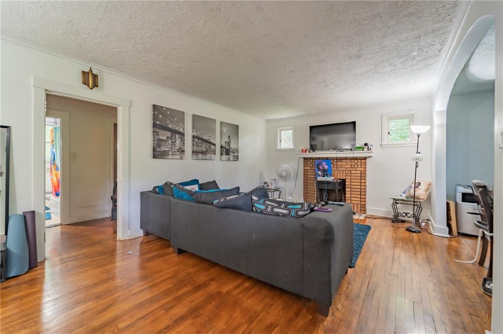 624 Frayne Street Pittsburgh, PA 15207 - Photo 4 of 21 a living room with furniture a flat screen tv and a fireplace