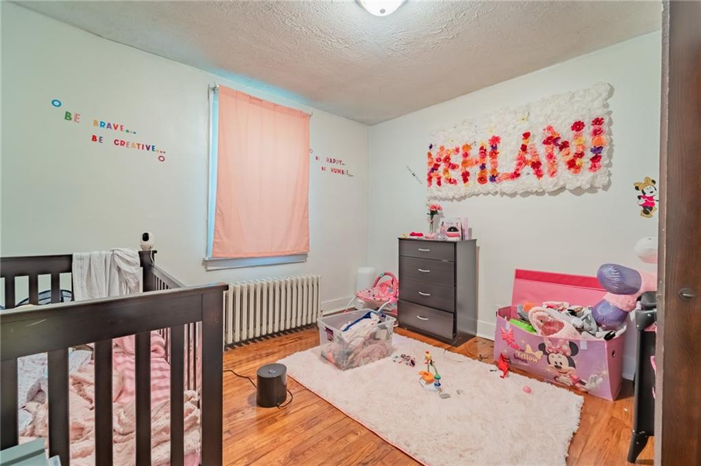 624 Frayne Street Pittsburgh, PA 15207 - Photo 9 of 21 a bedroom with furniture a rug and a book shelf
