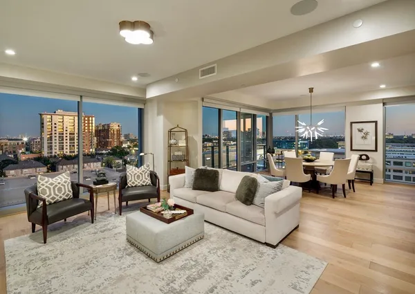 a living room with furniture and view of kitchen