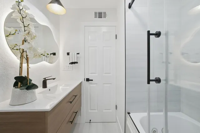 a bathroom with a glass shower door