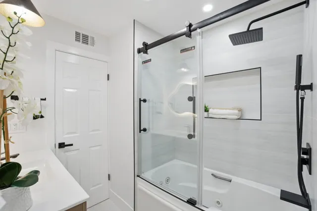 a bedroom with a bed and a potted plant