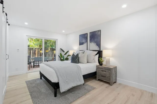 a spacious bedroom with a bed and a shower