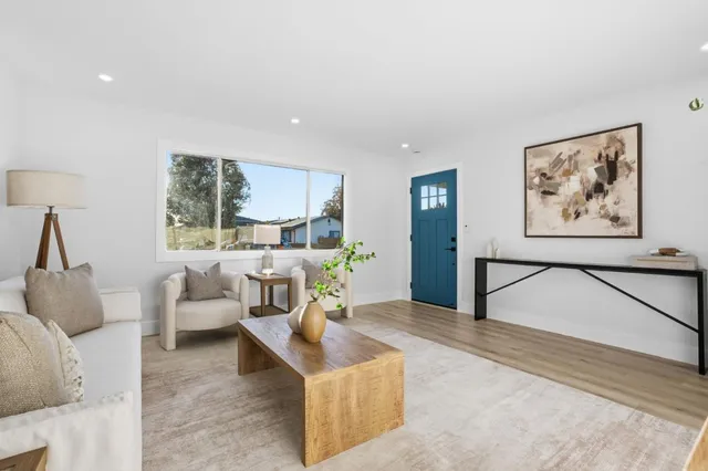 a living room with furniture and a large window