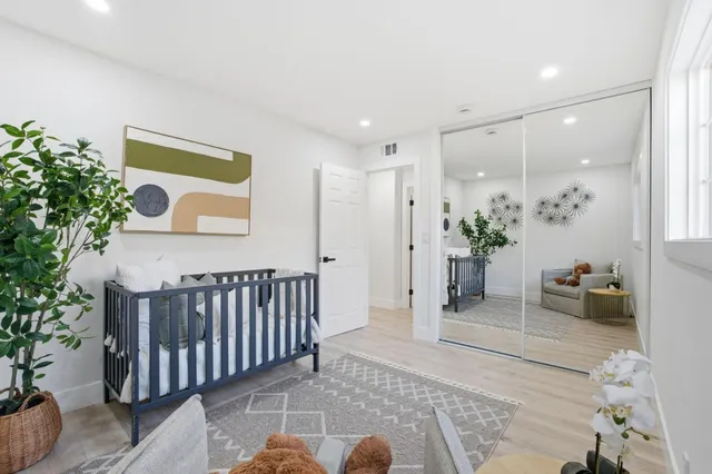 a bedroom with a bed and a large mirror