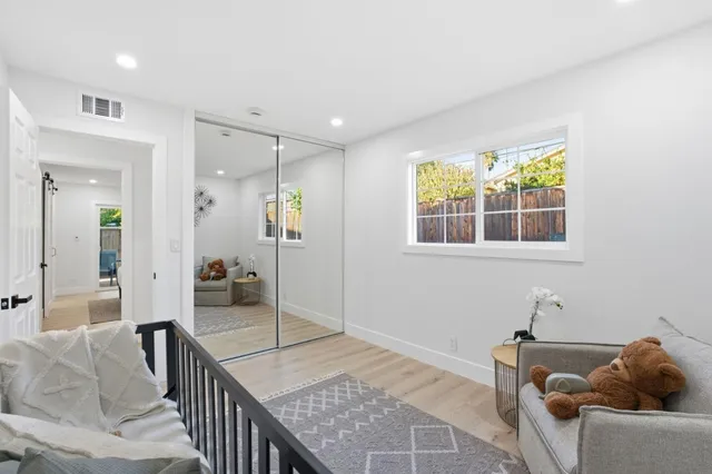 a bedroom with a bed and a potted plant