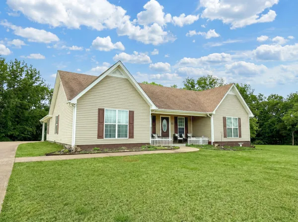 a front view of house with yard and green space