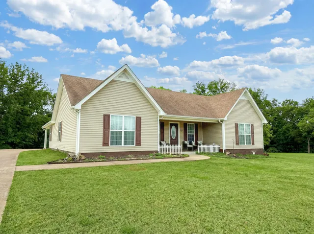 a front view of house with yard and green space