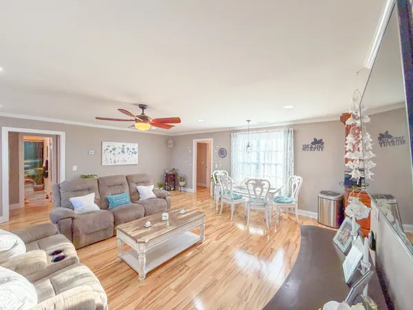 a living room with furniture and wooden floor