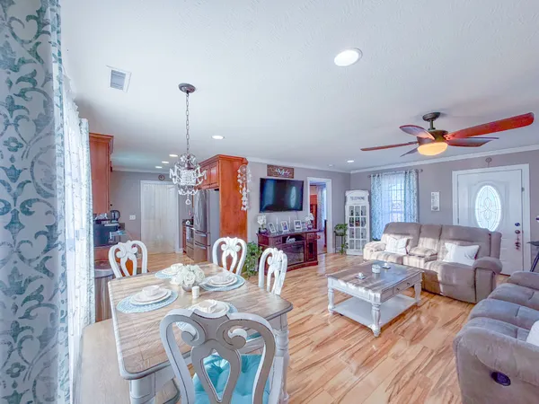 a living room with furniture and a chandelier