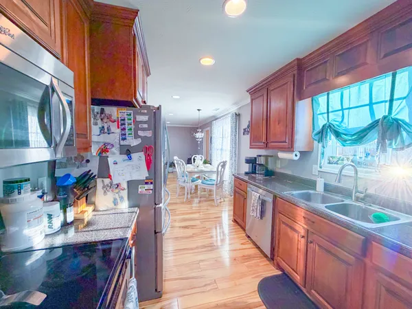 a kitchen filled counter top space a sink cabinets and appliances