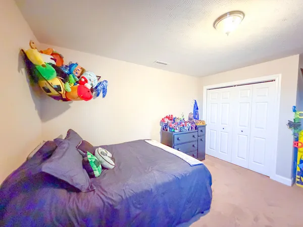 a bed room with a bed and a dresser