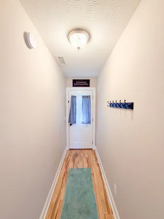 a view of a hallway with wooden floor