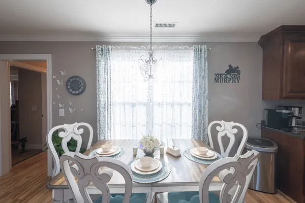 a dining room with furniture and window