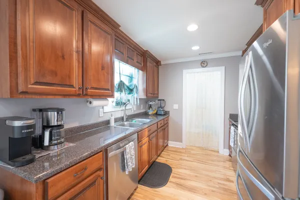 a kitchen with stainless steel appliances granite countertop a sink stove and refrigerator