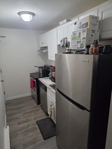 a kitchen with stainless steel appliances a refrigerator and a stove