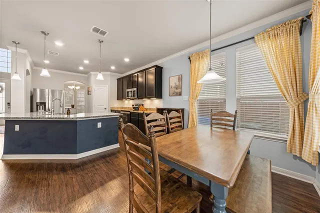 a large kitchen with stainless steel appliances granite countertop plenty wooden floors