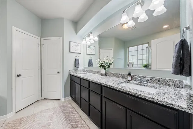 a bathroom with a tub sink and mirror