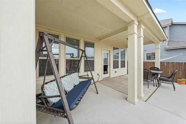 a view of a patio with table and chairs and potted plants