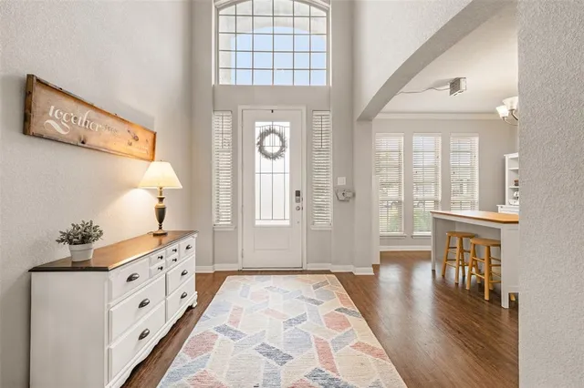a large white kitchen with a large window
