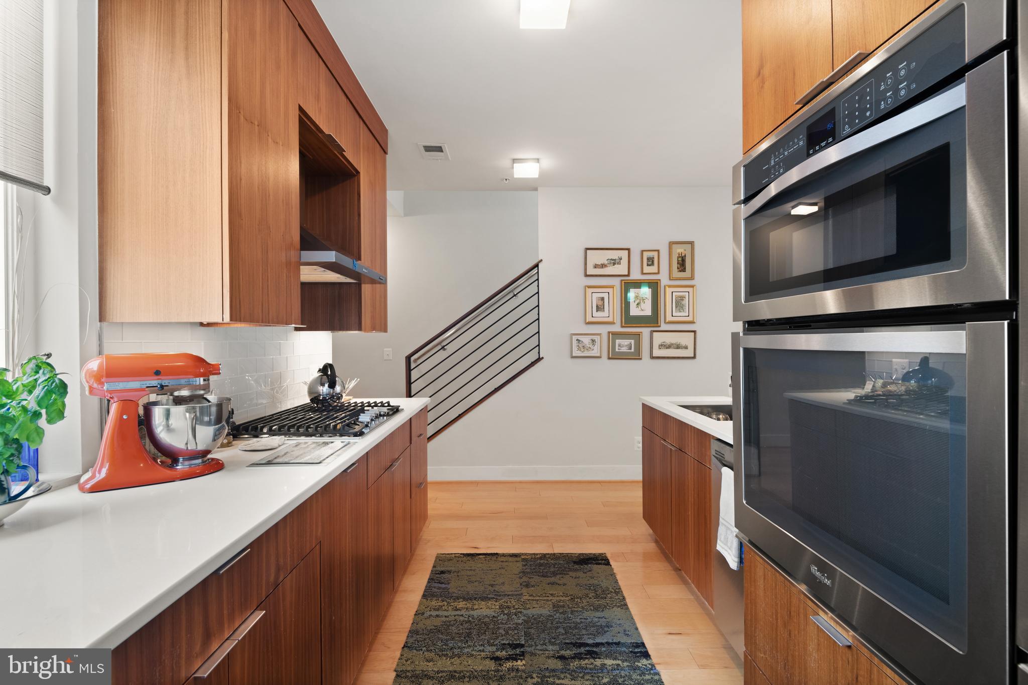1436 Chapin Street Northwest, Unit F Washington, DC 20009 - Photo 11 of 41 a kitchen with stainless steel appliances granite countertop a refrigerator and a stove top oven