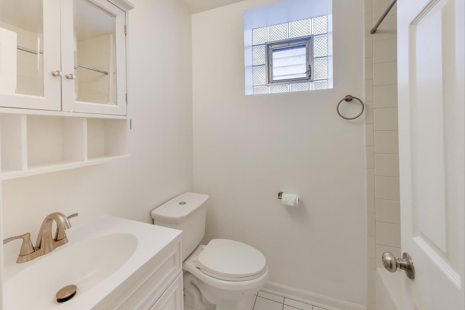 46 6th Avenue, Unit GJ La Grange, IL 60525 - Photo 13 of 15 a bathroom with a toilet sink and mirror