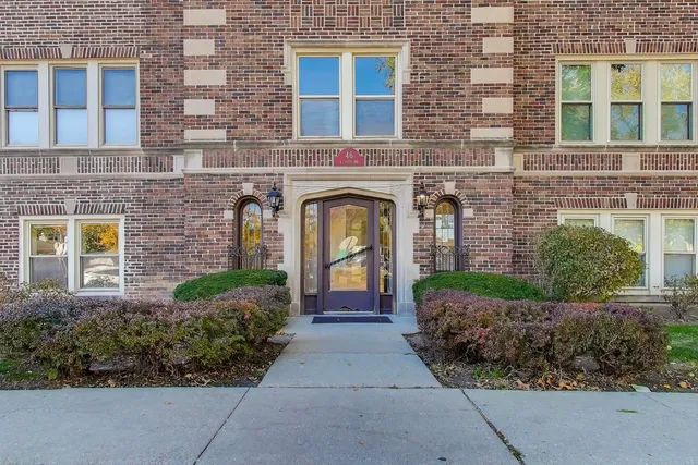 front view of a brick house with a yard