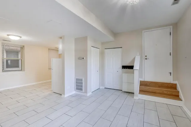 a view of kitchen with refrigerator and window