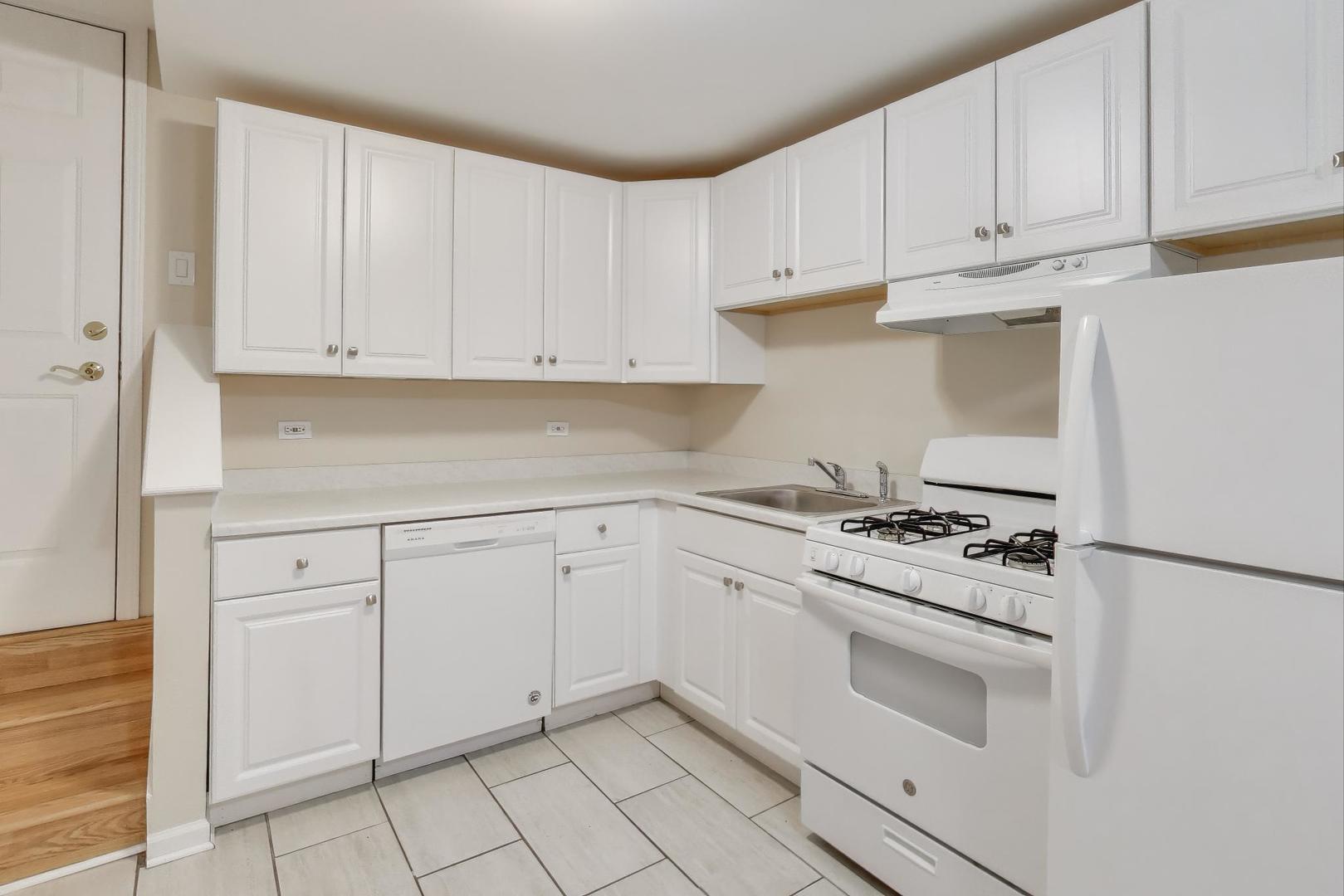46 6th Avenue, Unit GJ La Grange, IL 60525 - Photo 9 of 15 a kitchen with white cabinets and white appliances