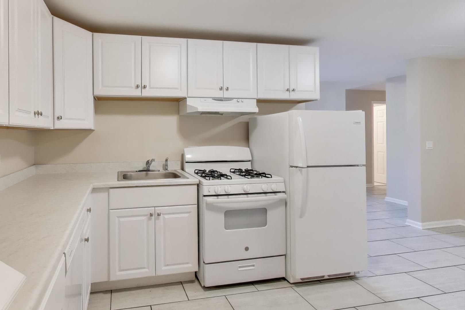 46 6th Avenue, Unit GJ La Grange, IL 60525 - Photo 10 of 15 a kitchen with white cabinets and white appliances
