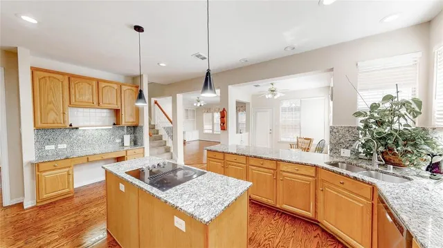 a spacious bedroom with a bed and a chandelier