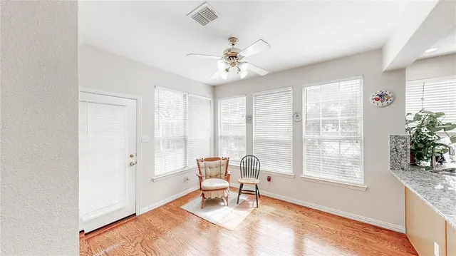 a view of an empty room with a fireplace and a window