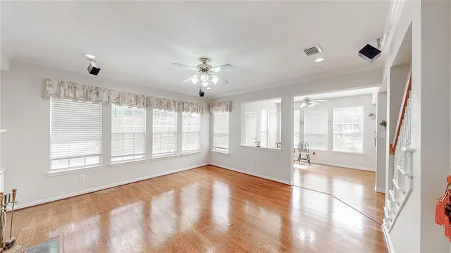 a view of a livingroom with wooden floor and a fireplace