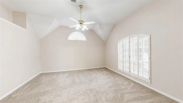 an empty room with windows and chandelier