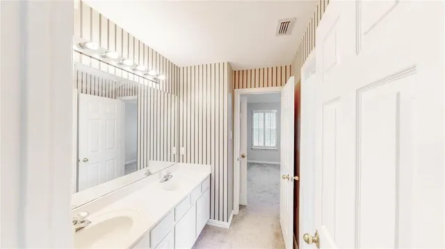 a en suite bathroom with a sink shower and a mirror