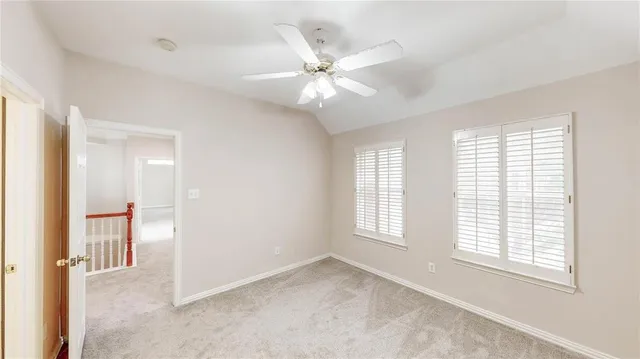 a view of a swimming pool with a yard and plants